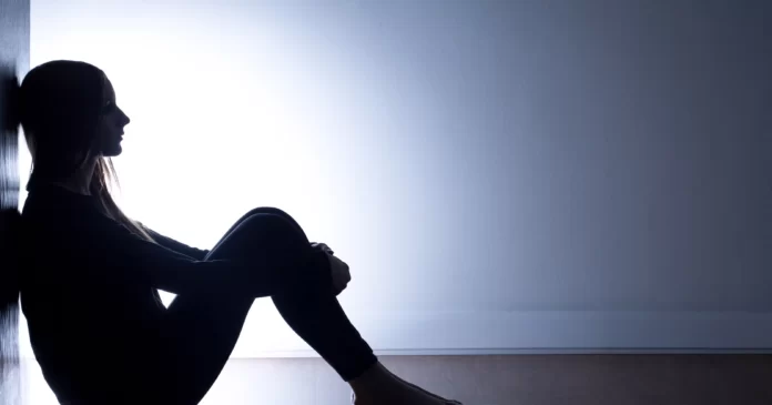 Depressed Girl Sitting in Dark