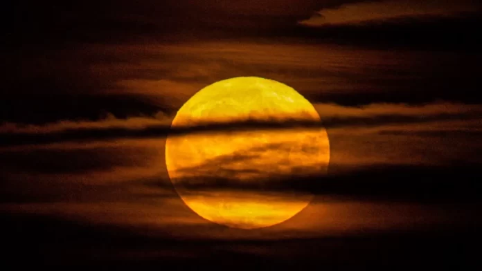 Yellow Full Moon Behind Clouds
