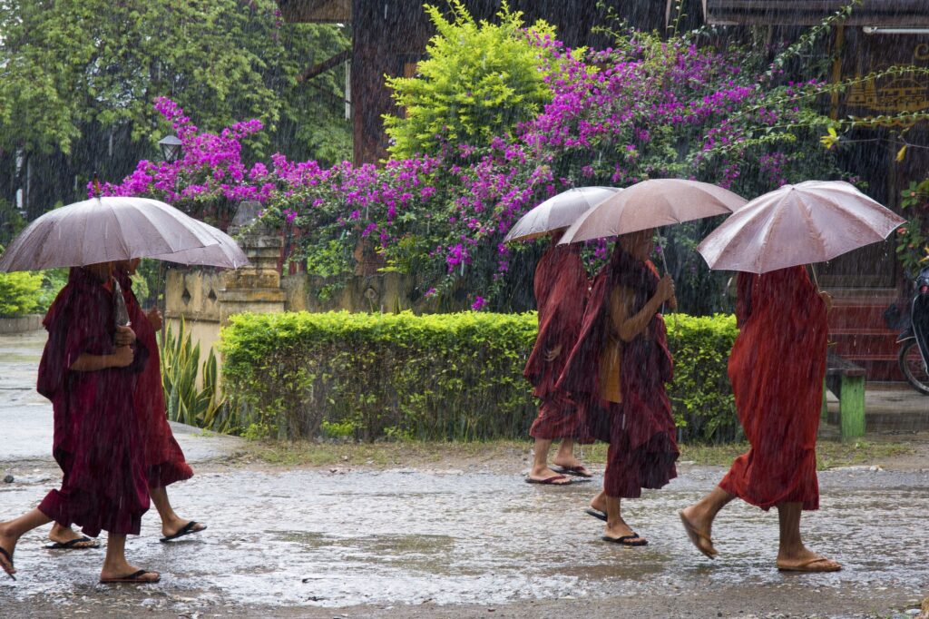 People walking in Rain under Umbrella