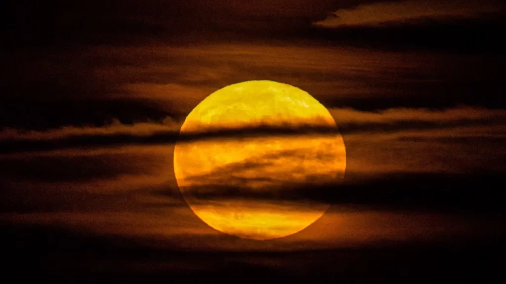 Yellow Full Moon Behind Clouds