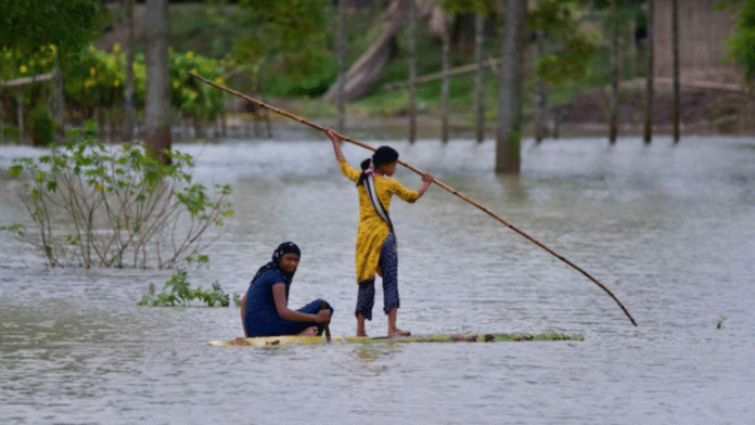 Flooded village in Assam during monsoon Flooded village in Assam affected by monsoon rains