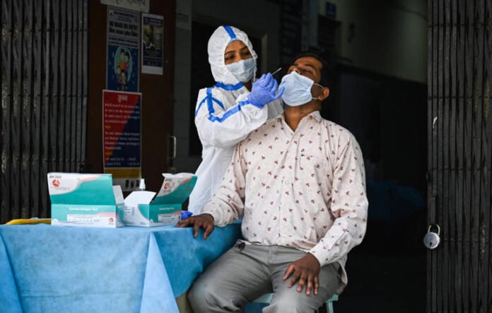 Health worker conducting Covid test in India