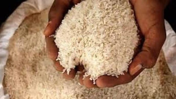 Workers storing rice sacks in Mizoram warehouse before monsoon