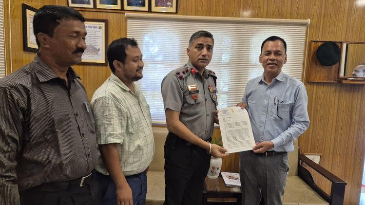 Officials seated in a room during a meeting on migrant deportation in Tripura