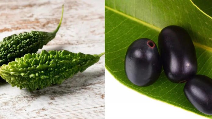 Glass of fresh Jamun-Karela juice with raw karela and jamun fruits placed on a table