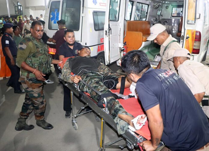 An injured security personnel being taken to the Regional Institute of Medical Sciences hospital