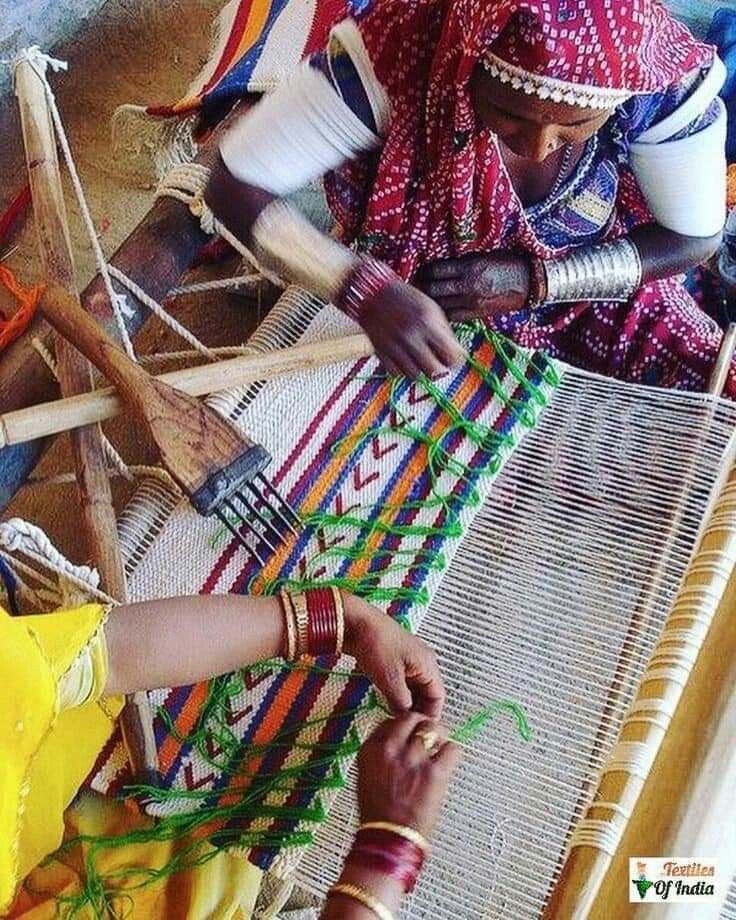 Artisans weaving on looms