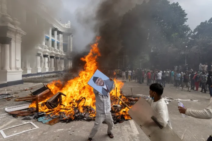 epa12364608-protester-prepares-burn-picture-1022064405 Rajyalaxmi Chitrakar