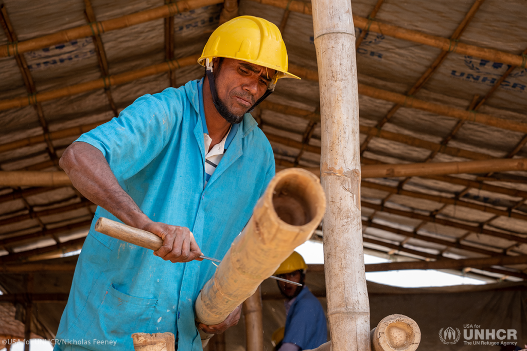 Workers handling bamboo materials at an industrial processing facility in Mizoram