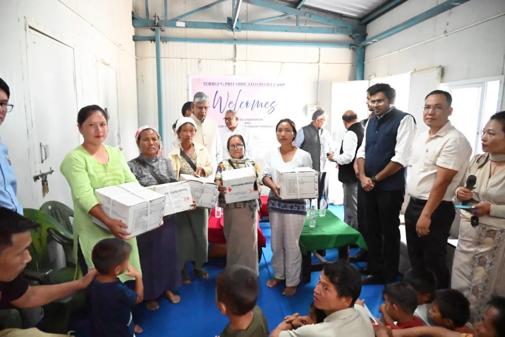 Judicial inquiry commission members interacting with displaced families during a relief camp visit in Manipur