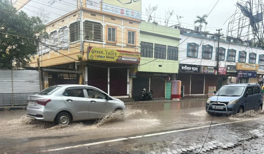Rain-soaked streets and cloudy skies in Tripura during unusually cool weather and widespread rainfall conditions.