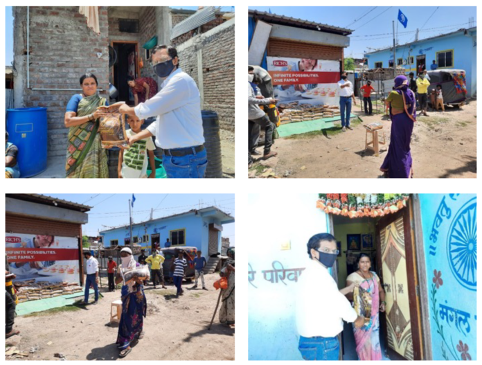 Beneficiaries collecting essential food items from a government-supported distribution center in Assam.