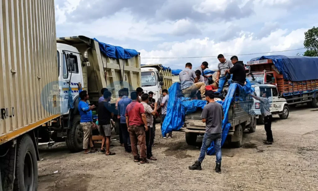Freight trucks remain stranded on NH-2 in Manipur as a partial economic blockade disrupts commercial transportation.