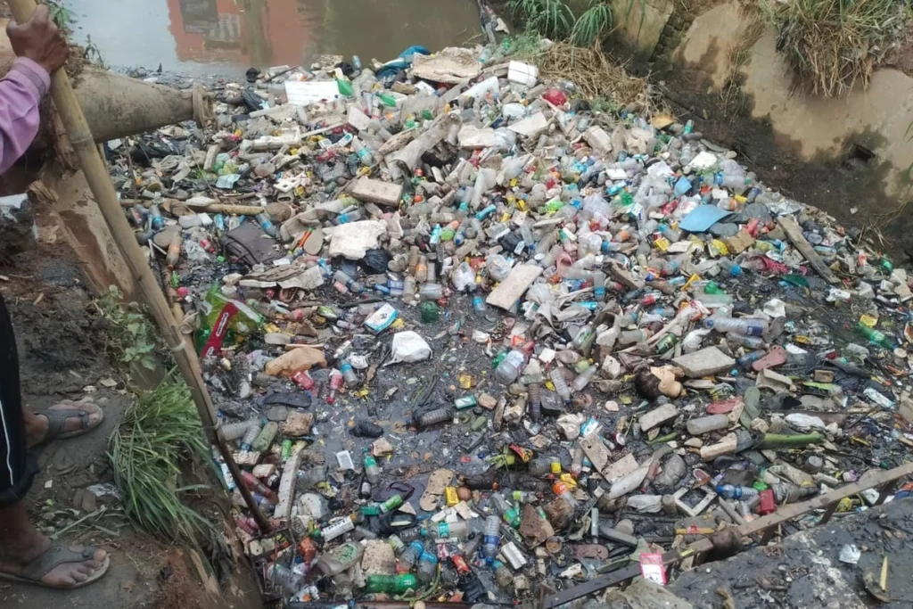 Municipal workers cleaning major drainage channels in Guwahati to prevent monsoon flooding and improve sanitation.