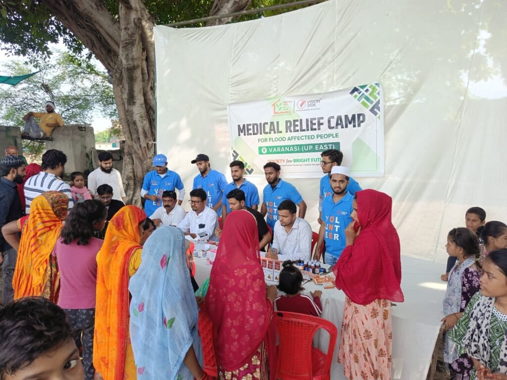 Doctors treating patients and distributing water purification kits in Assam flood relief camps.