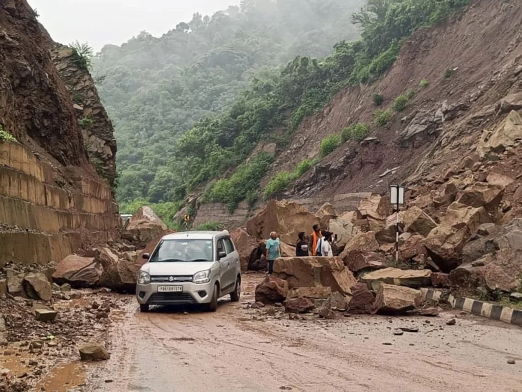 Heavy machinery clears mud and rock debris from National Highway 6 after monsoon landslides disrupted transport routes.