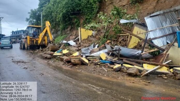 Workers and heavy machinery carrying out emergency repairs on landslide-damaged district roads in Nagaland.
