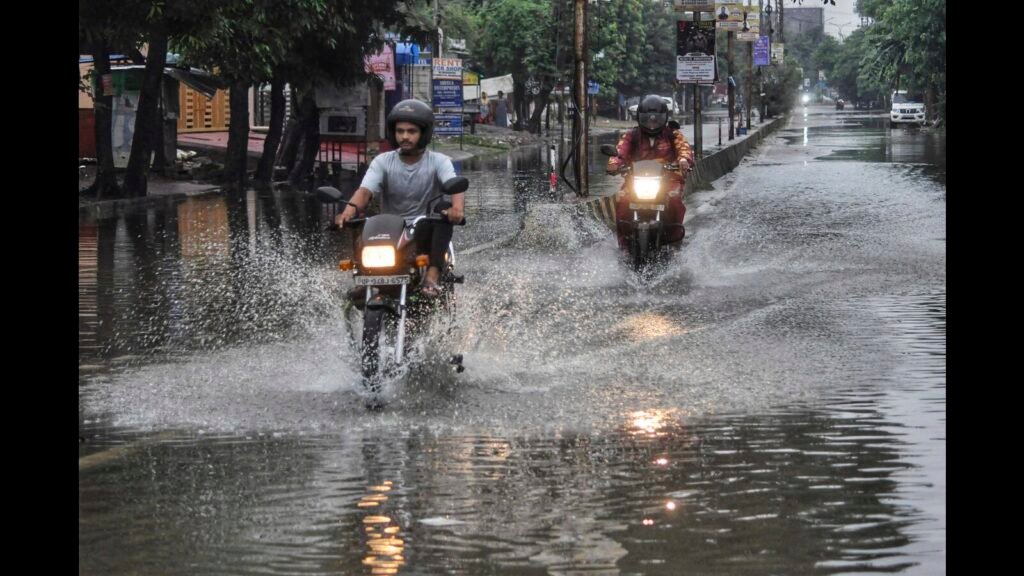 Officials discussing solutions to monsoon waterlogging issues along a National Highway construction stretch.