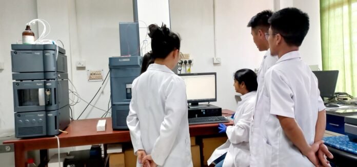 Students and researchers working in a high-performance computing laboratory at Mizoram Central University with advanced computer systems.