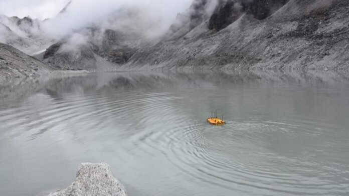 Emergency personnel install acoustic monitoring equipment near a high-altitude glacial lake in Sikkim during the monsoon season.