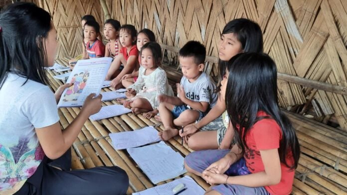 Students attending a lecture on tribal history and indigenous languages at Arunachal State University.