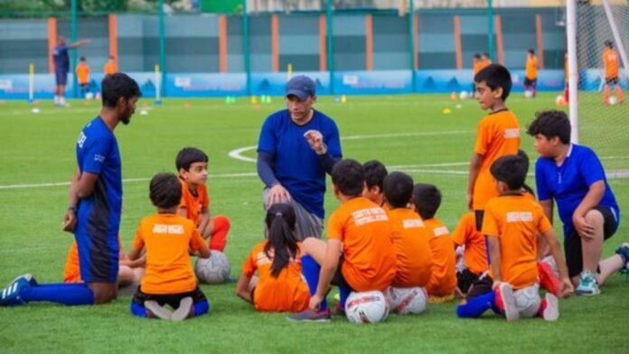 Young football players practice on a local field as sports council approves infrastructure funding to improve football facilities in South Tripura.