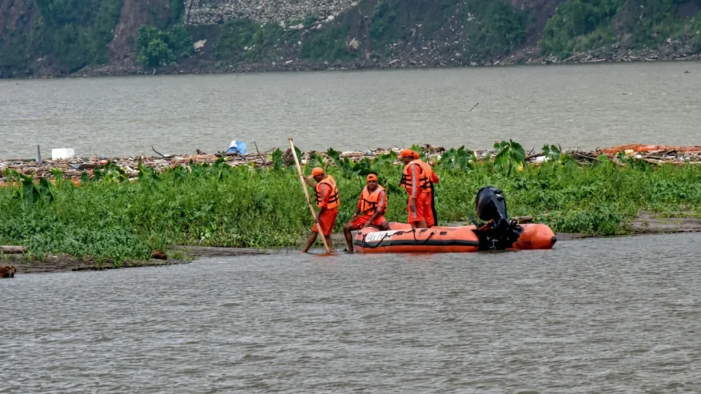 Rescue teams inspect a landslide-hit hillside in Arunachal Pradesh after heavy monsoon rain triggered a deadly slope collapse.