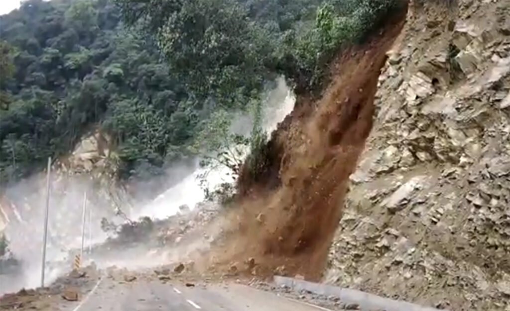 Military engineers clear landslide debris from a mountain road to restore access to Tawang during the monsoon season.