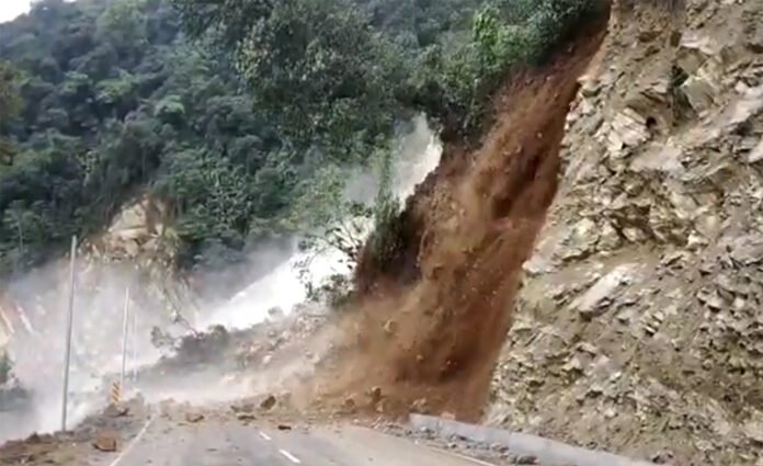 Military engineers clear landslide debris from a mountain road to restore access to Tawang during the monsoon season.