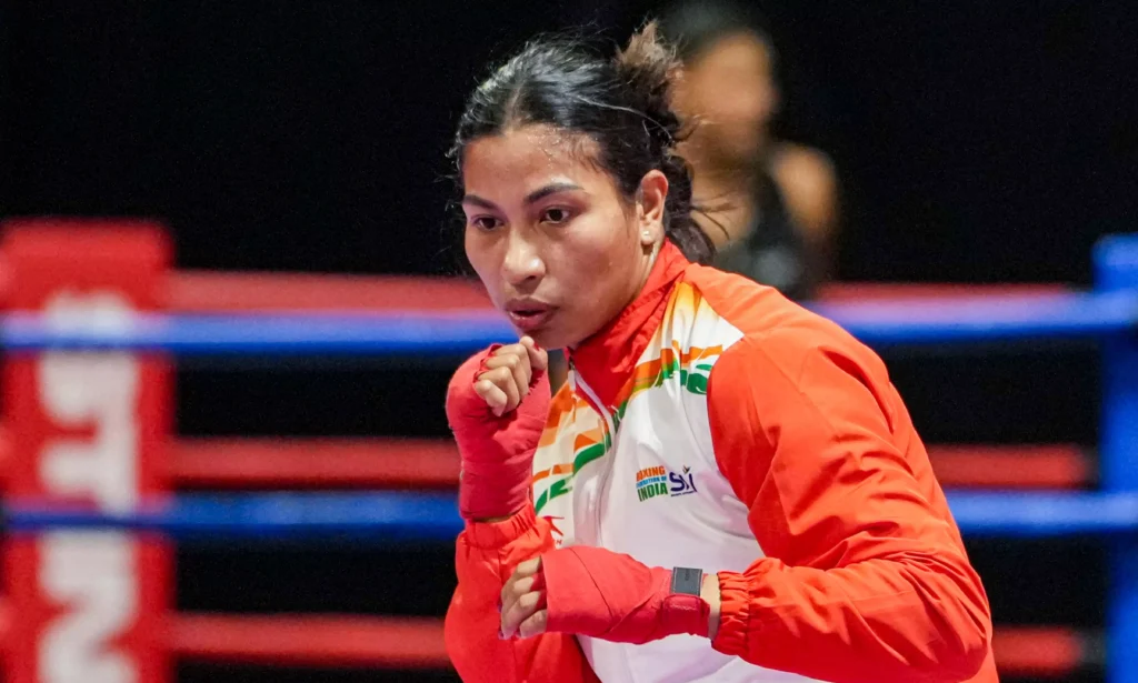 Indian boxing champion Lovlina Borgohain holds the national flag after being named India’s official flag bearer for the Commonwealth Games.