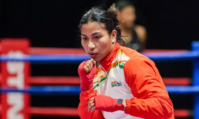 Indian boxing champion Lovlina Borgohain holds the national flag after being named India’s official flag bearer for the Commonwealth Games.