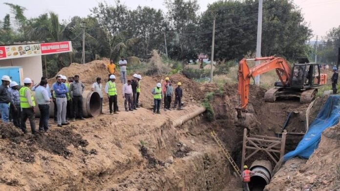 Workers install clean drinking water pipelines in a rural village as part of a water supply expansion project covering 12 villages in Sepahijala.