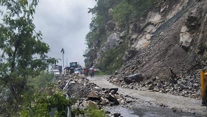 Landslide debris partially blocks National Highway 208 as road crews work to restore traffic and repair damaged sections following heavy rainfall.