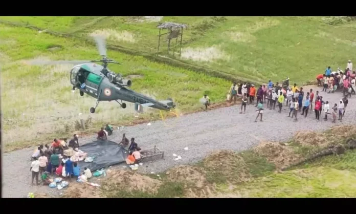 Indian Air Force helicopters conduct emergency food drops over flood-affected villages in the Brahmaputra valley during a relief operation.