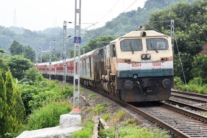 A passenger train travels along the Badarpur railway corridor as services continue uninterrupted despite heavy monsoon rainfall in neighboring states.