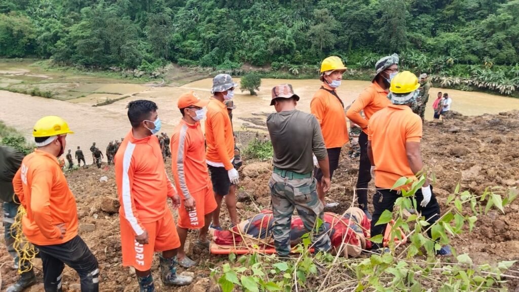 Young Mizo Association volunteers collectively work to recover a vehicle after it crashes off a cliffside road, demonstrating tlawmngaihna.