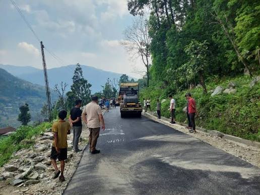 Road widening and structural maintenance work causes intermittent daytime traffic restrictions along a road in Soreng, Sikkim.
