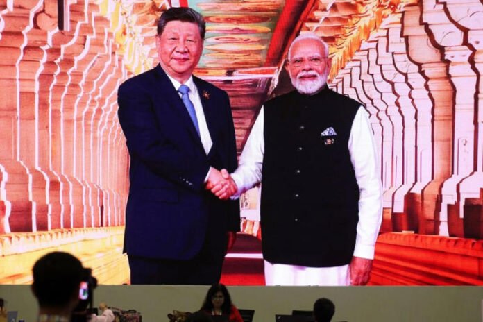 A screen shows India’s Prime Minister Narendra Modi as he greets Chinese President Xi Jinping on his arrival for the BRICS Summit.