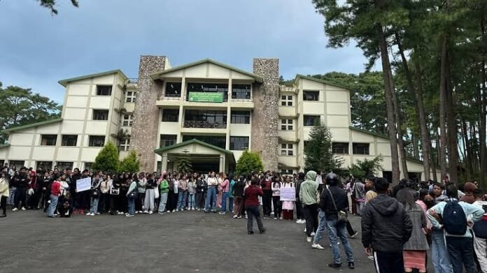 NEHU Students' Union members stage a sit-in in Shillong demanding improved hostel infrastructure at North-Eastern Hill University.